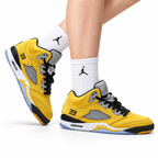 Air Jordan 5 Retro University Gold Black Sneakers on-foot product image on a pure white background