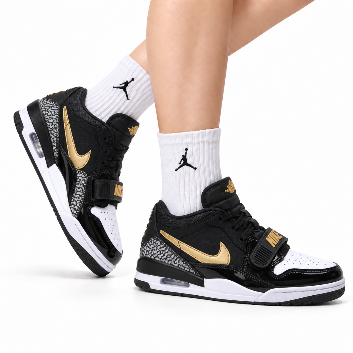 Jordan Legacy 312 Low Black White Metallic Gold sneakers on feet with Jordan socks