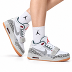 Jordan Legacy 312 Low White Cement Grey Gum sneakers on feet with Jordan socks